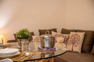 a living room with a couch and a glass table at Aventino apartment in Rome