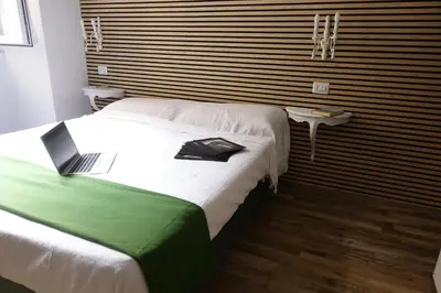 a bedroom with a bed with a laptop on it at Piccolo Principe Suite in Rome