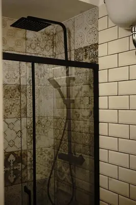 a shower with a hose in a bathroom at Piccolo Principe Suite in Rome
