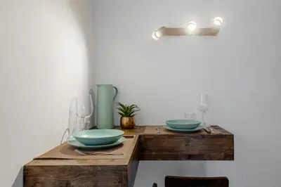 a wooden table with two blue bowls on it at Suite Vaticano in Rome