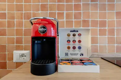 a red blender sitting next to a box of donuts at Suite Vaticano in Rome