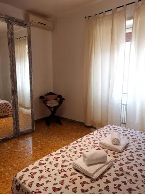 a bedroom with a bed and a mirror with towels on it at Appartamento di Sara in Rome