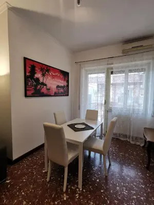a dining room with a white table and chairs at Appartamento di Sara in Rome