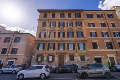 a large building with cars parked in front of it at Castel Sant'Angelo SuiteLux in Rome