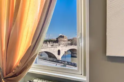 a window with a view of a bridge at Castel Sant'Angelo SuiteLux in Rome