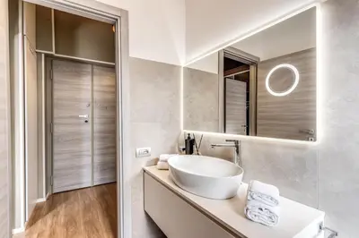 a bathroom with a sink and a mirror at Castel Sant'Angelo SuiteLux in Rome