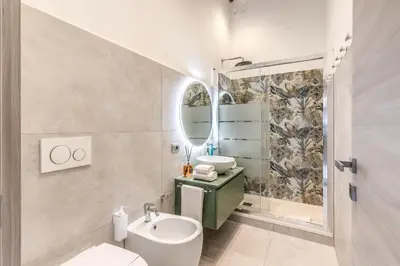 a bathroom with a sink toilet and a mirror at Castel Sant'Angelo SuiteLux in Rome