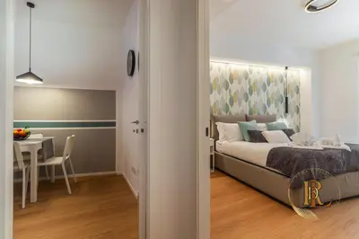 a bedroom with a bed and a dining room with a table at Silverius - Roma's Delightful Lodges in Rome
