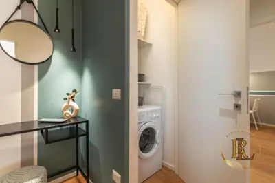 a laundry room with a washer and dryer at Silverius - Roma's Delightful Lodges in Rome