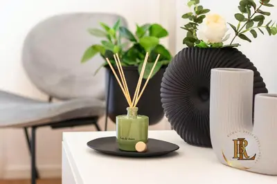 a table with a vase with bamboo sticks in it at Silverius - Roma's Delightful Lodges in Rome