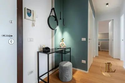 a hallway with a glass table and a mirror at Silverius - Roma's Delightful Lodges in Rome