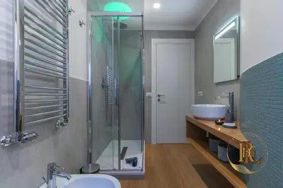 a bathroom with a glass shower and a sink at Silverius - Roma's Delightful Lodges in Rome