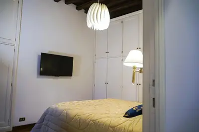 a bedroom with a bed and a tv on the wall at Appartamento Roma centro in Rome