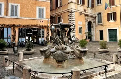 a fountain in the middle of a street with buildings at Appartamento Roma centro in Rome
