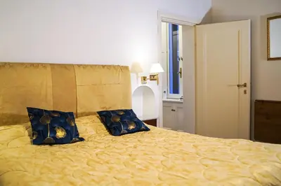 a bedroom with a bed with two blue pillows at Appartamento Roma centro in Rome