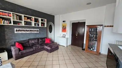 a living room with a brown couch and red pillows at ST. PETER'S ROOMS SUITE in Rome
