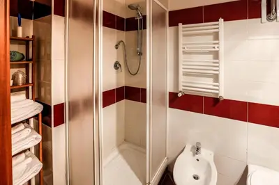 a bathroom with a shower with a toilet and a sink at Vanella Rome Domus in Rome