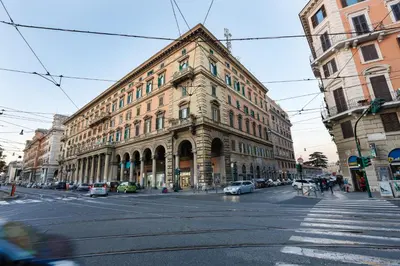 an old building on a city street with cars parked at Vanella Rome Domus in Rome