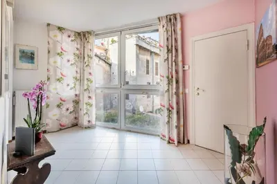 a room with a large window with pink curtains at Minerva al 5 in Rome