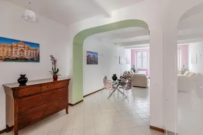 a living room with a dresser and a dining room at Minerva al 5 in Rome