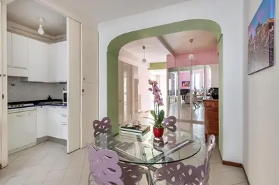 a kitchen with a glass table and some chairs at Minerva al 5 in Rome