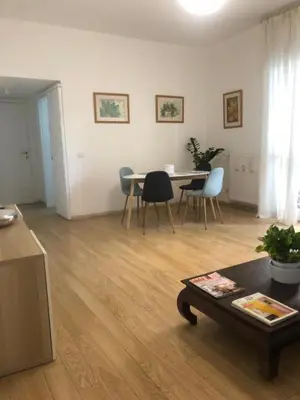 a living room with a table and chairs at Rizzola casa e appartamento per vacanze in Rome
