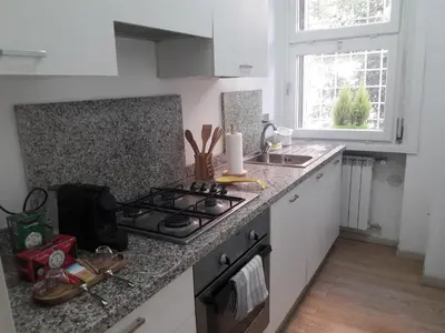 a kitchen with a stove and a counter top at Rizzola casa e appartamento per vacanze in Rome