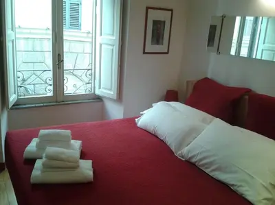 a bedroom with a bed with towels on it at Barberini 360 in Rome