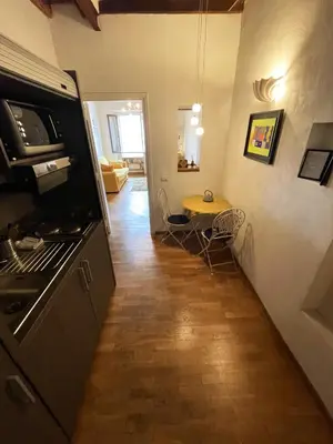 a kitchen with a stove and a table in it at Historical Central Rome Flat in Rome