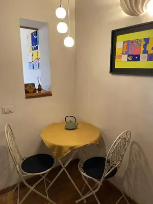 a table and chairs in a room with a yellow table at Historical Central Rome Flat in Rome