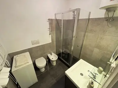 a bathroom with a shower and a toilet and a sink at Historical Central Rome Flat in Rome