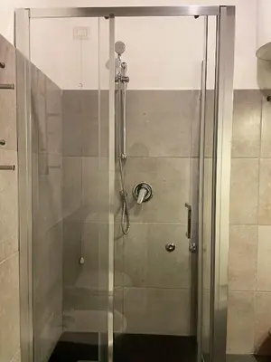 a shower with a glass door in a bathroom at Historical Central Rome Flat in Rome