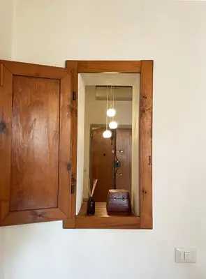a mirror hanging on a wall in a room at Historical Central Rome Flat in Rome
