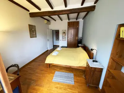 a bedroom with a bed and a wooden floor at Historical Central Rome Flat in Rome