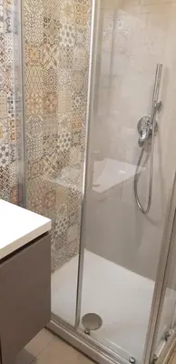 a shower with a glass door in a bathroom at Trastevere Residenze in Rome