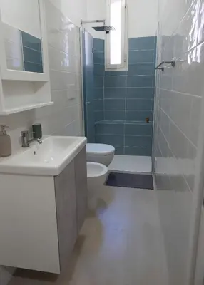 a bathroom with a toilet and a sink and a shower at Stazione Termini-San Lorenzo Apt House of Wonders in Rome