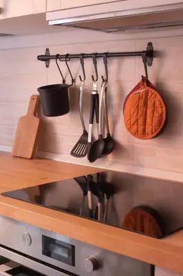 a kitchen with utensils hanging on a wall at Stazione Termini-San Lorenzo Apt House of Wonders in Rome