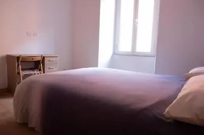 a bedroom with a bed and a dresser and a window at Stazione Termini-San Lorenzo Apt House of Wonders in Rome