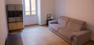 a living room with a couch and a television at Stazione Termini-San Lorenzo Apt House of Wonders in Rome