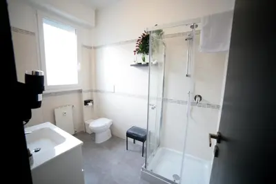 a bathroom with a shower and a toilet and a sink at Roma Imperial Suites in Rome