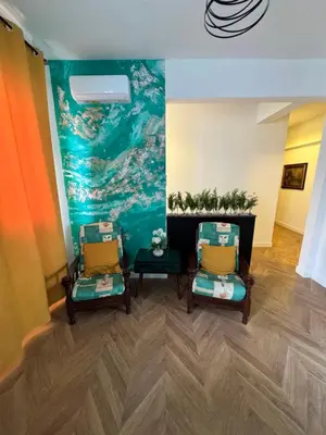 two chairs in a room with a painting on the wall at Roma Imperial Suites in Rome