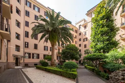 a palm tree in front of a building at Domus Pietrae in Rome
