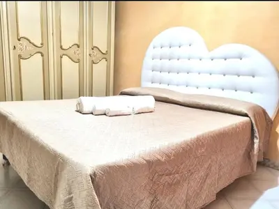 a bed with two white towels on top of it at Appartamento Antico AMOR in Rome