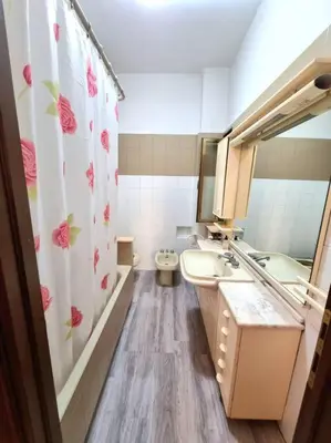 a bathroom with a sink and a toilet and a mirror at Appartamento Antico AMOR in Rome