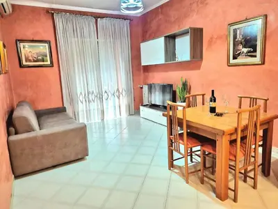a living room with a wooden table and a couch at Appartamento Antico AMOR in Rome
