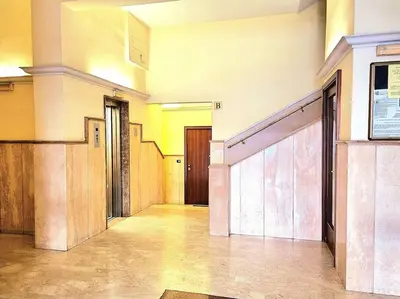 an empty hallway of a building with doors and stairs at Appartamento Antico AMOR in Rome