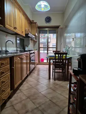 a kitchen with a table and a dining room at Appartamento Antico AMOR in Rome