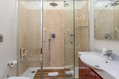 a bathroom with a shower and a sink at Skyline Penthouse with Private Rooftop in Rome