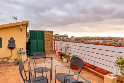 a balcony with chairs and a view of the city at Skyline Penthouse with Private Rooftop in Rome