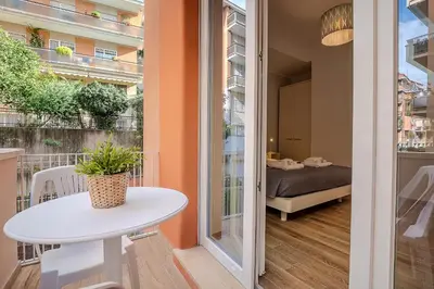 a small white table in a room with a bed at Emily Valles Apartment Saint Peter's in Rome